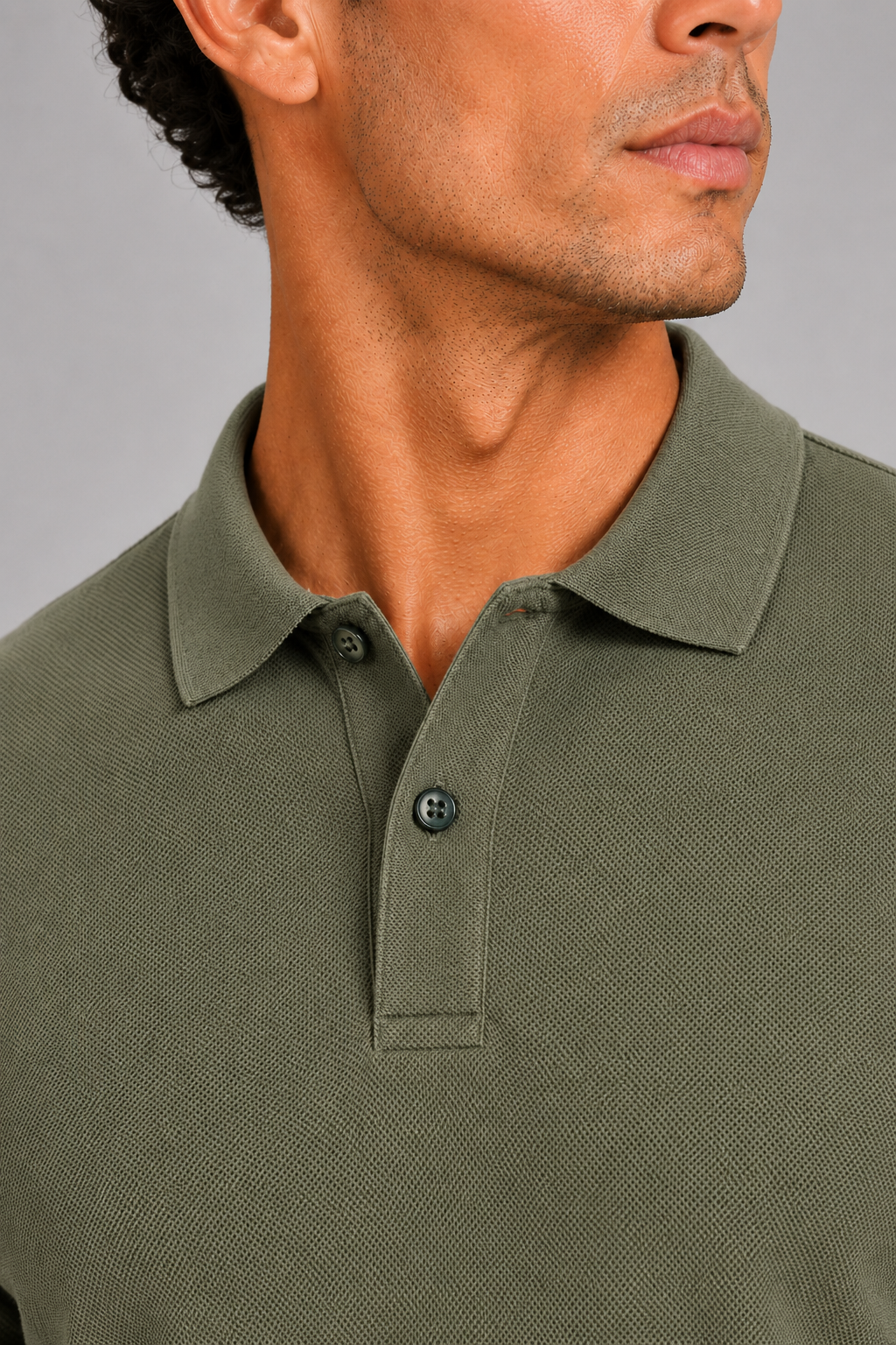 Close up of army green polo shirt showing smooth silk touch fabric and refined collar detail