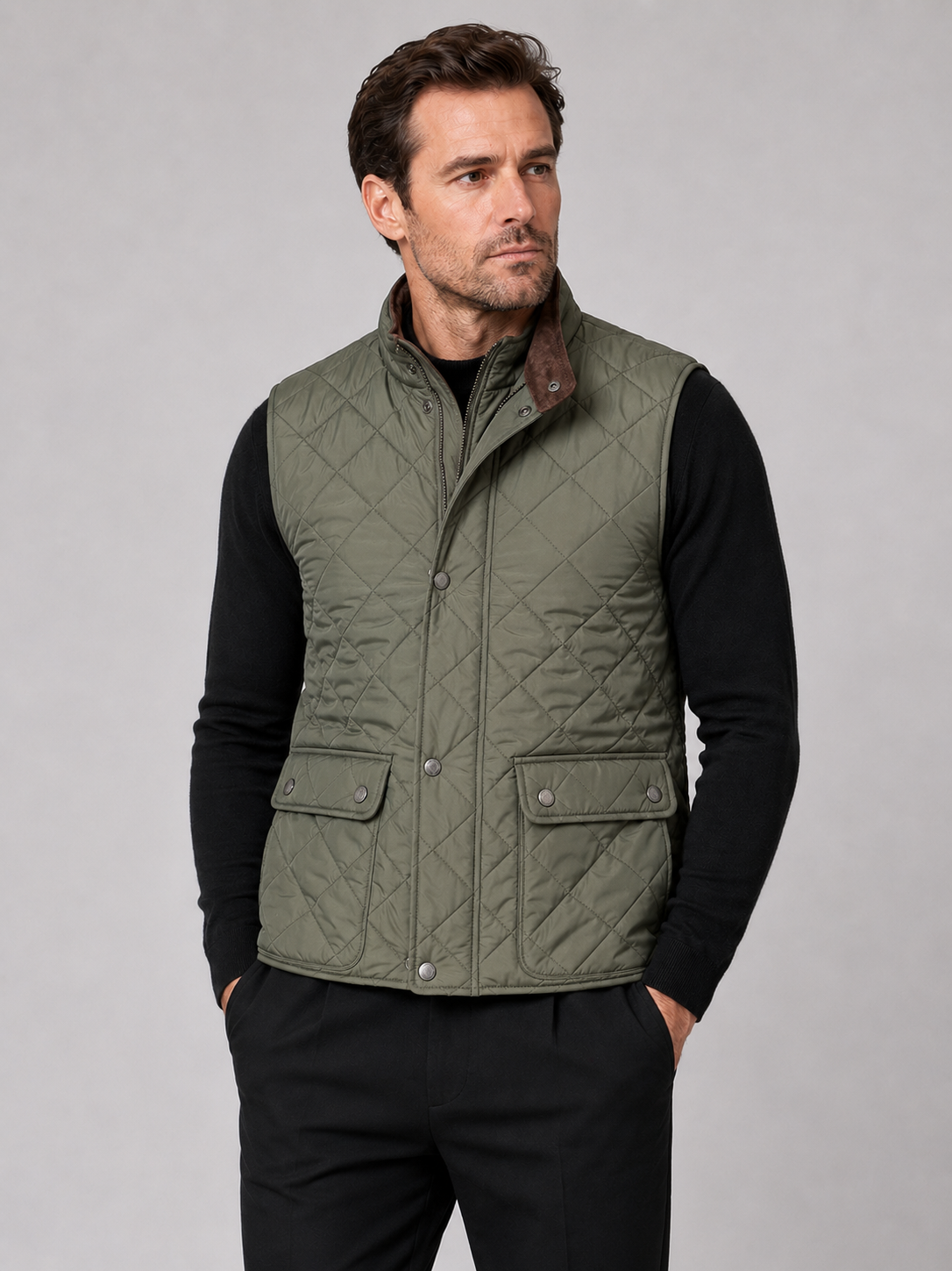 Front view of a man wearing an army green quilted vest with a polo collar, padded construction, and multiple utility pockets