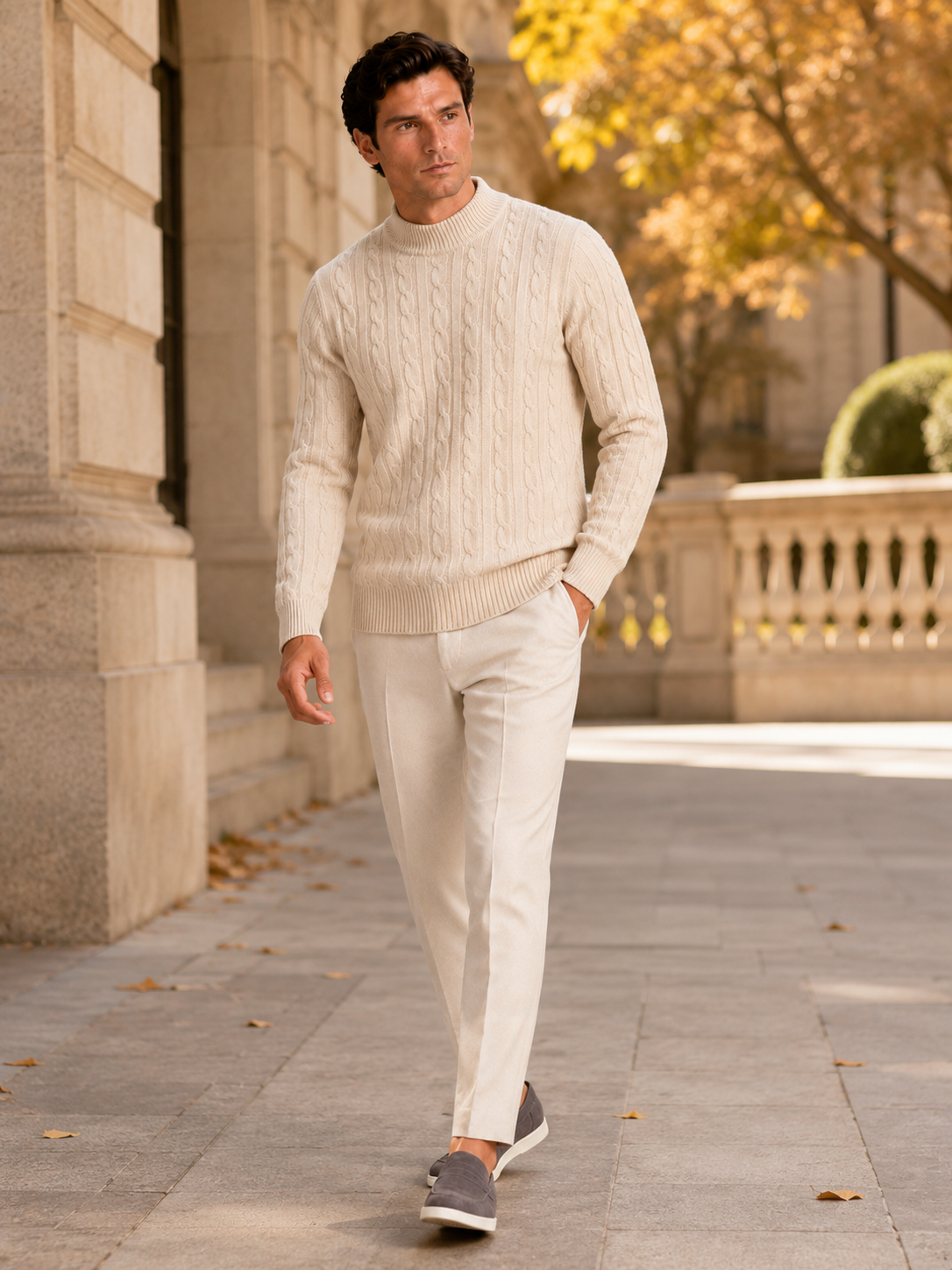 Man styling beige wool cable knit mock neck sweater in a refined fall winter lifestyle outfit