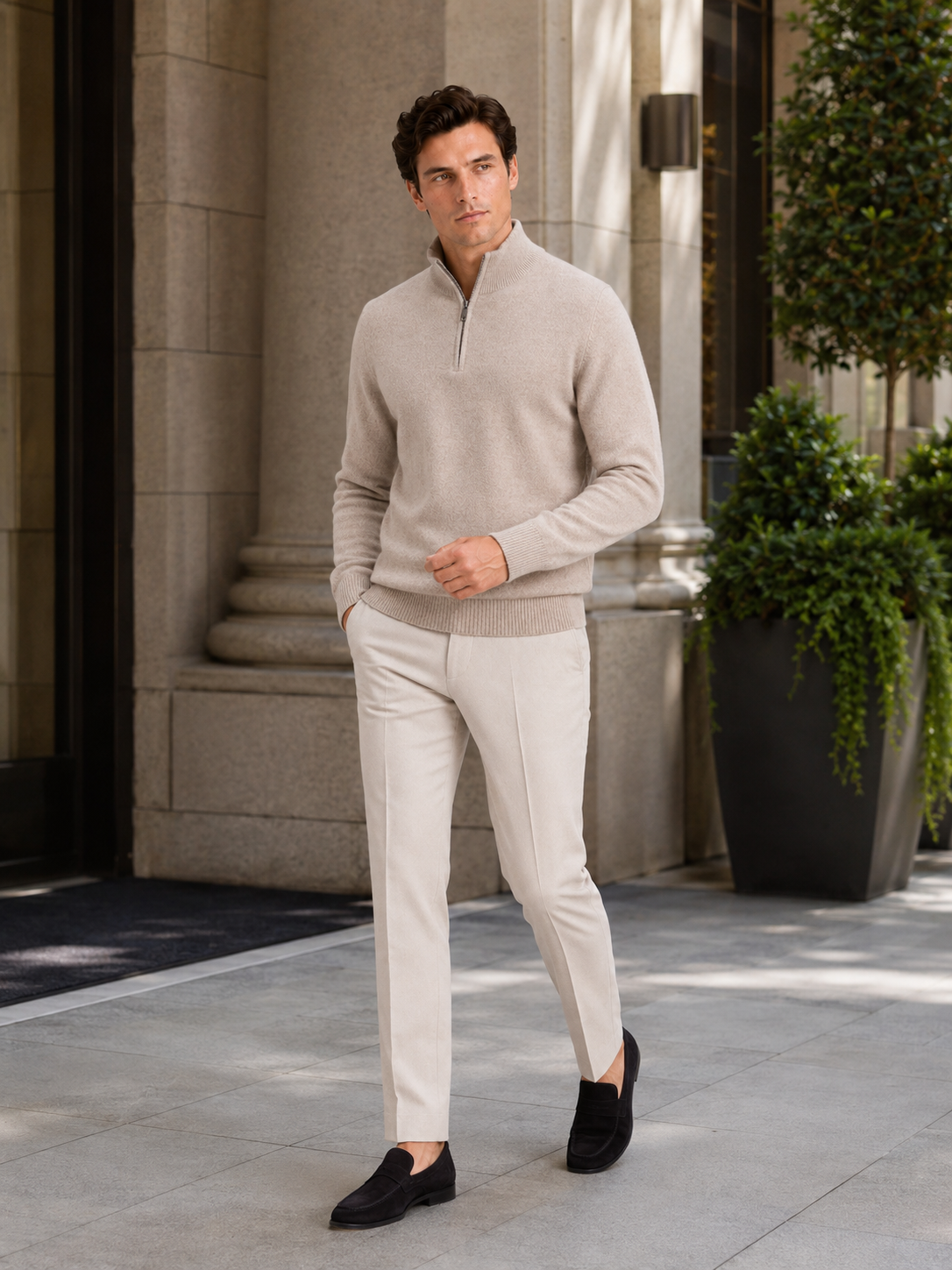 Man styling beige wool half zip mock neck sweater in a refined fall winter lifestyle outfit