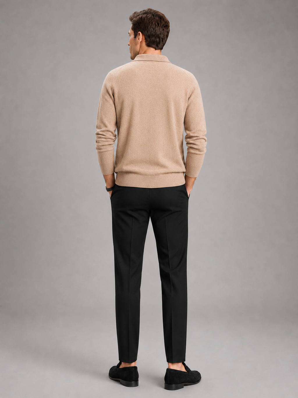 Back view of a man wearing a black argyle cardigan showing the thick knit fabric, long sleeves, collar, and comfortable fit