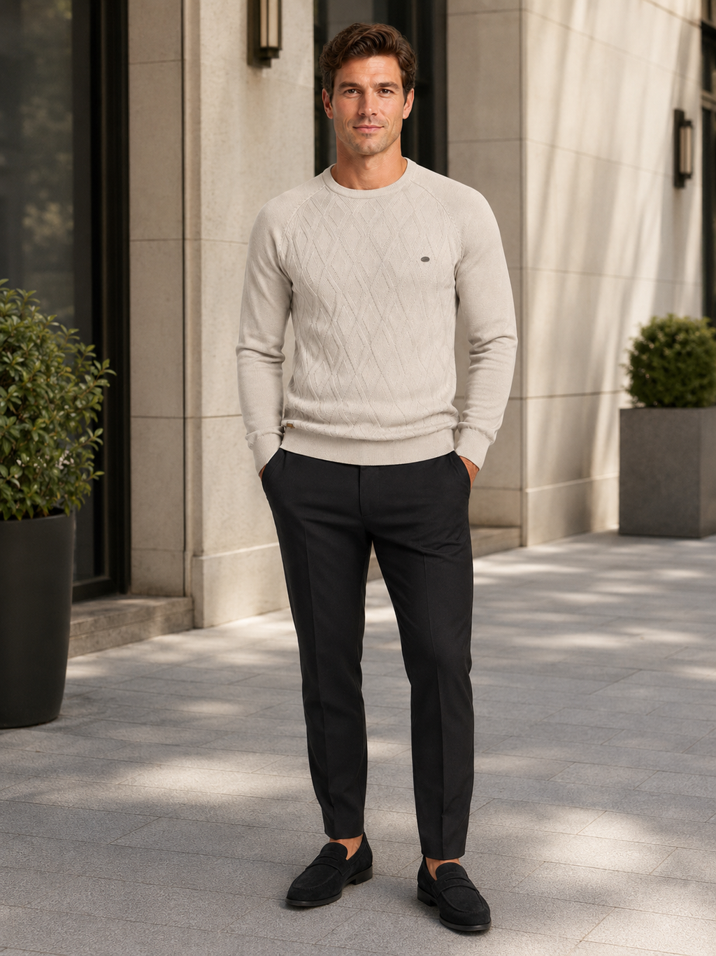 Man wearing a beige argyle crew neck sweater in a refined business casual winter outfit