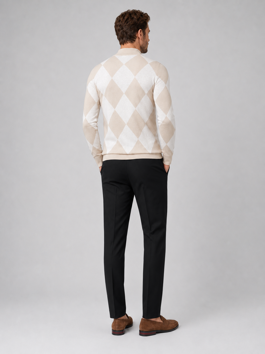 Back view of a man wearing a beige argyle turtleneck sweater showing the slim fit, long sleeves, and warm knit fabric