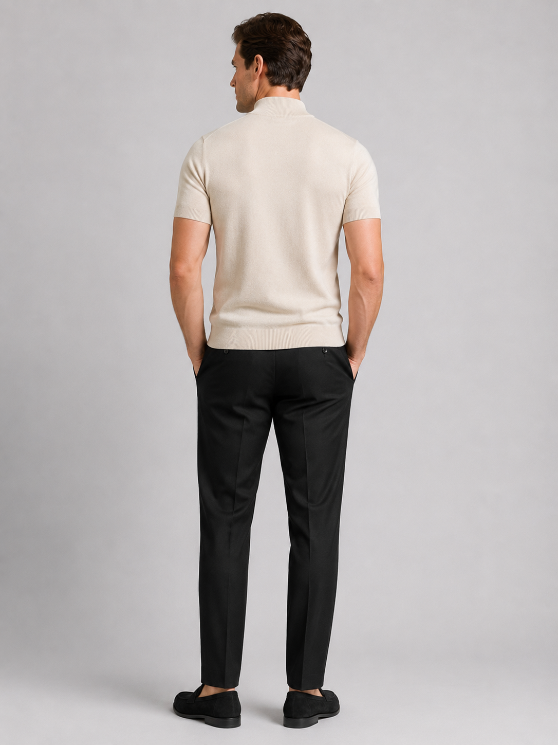 Back view of a man wearing a beige argyle turtleneck T-shirt showing the fitted silhouette, short sleeves, and smooth knit fabric