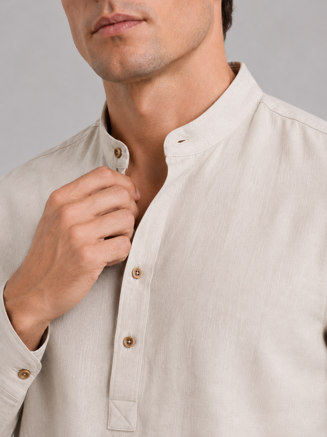 Close up of beige band collar shirt showing lightweight breathable fabric and clean collar detail