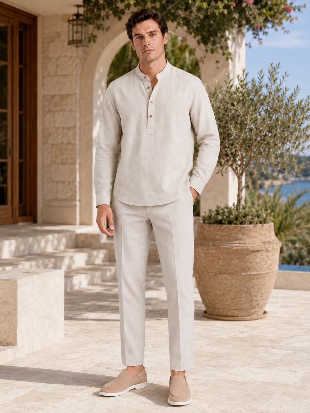 Man styling beige band collar shirt in a relaxed coastal vacation lifestyle outfitv