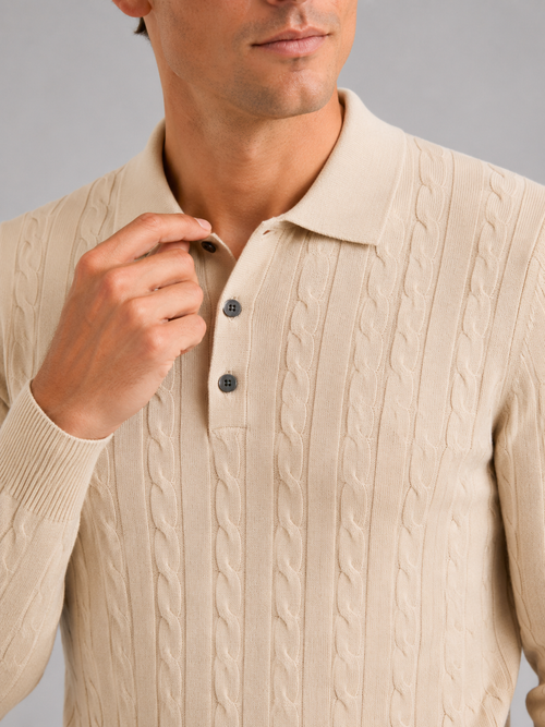 Close up of beige cable knit polo showing soft textured fabric and refined collar detail