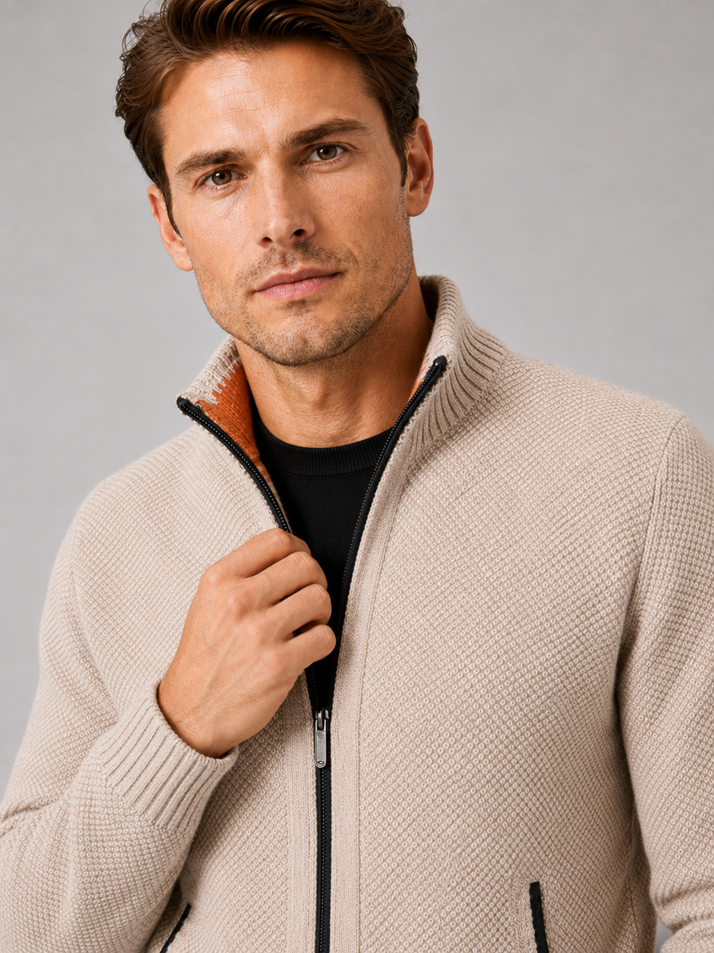 Close up of beige fleece cardigan showing soft knit texture, full zip front, and warm fleece lining detail