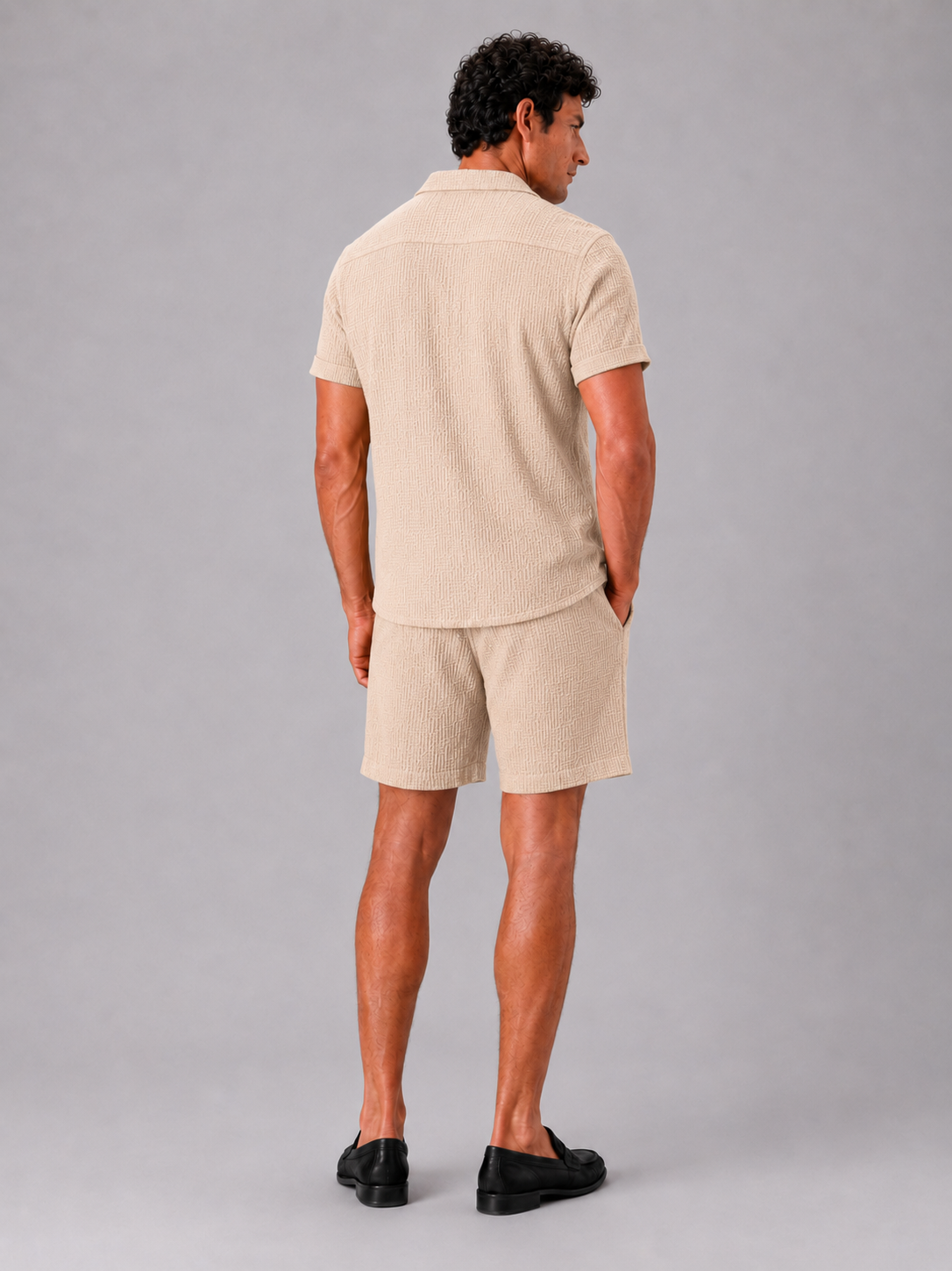 Man styling beige jacquard cotton two piece set in a relaxed summer lifestyle outfit