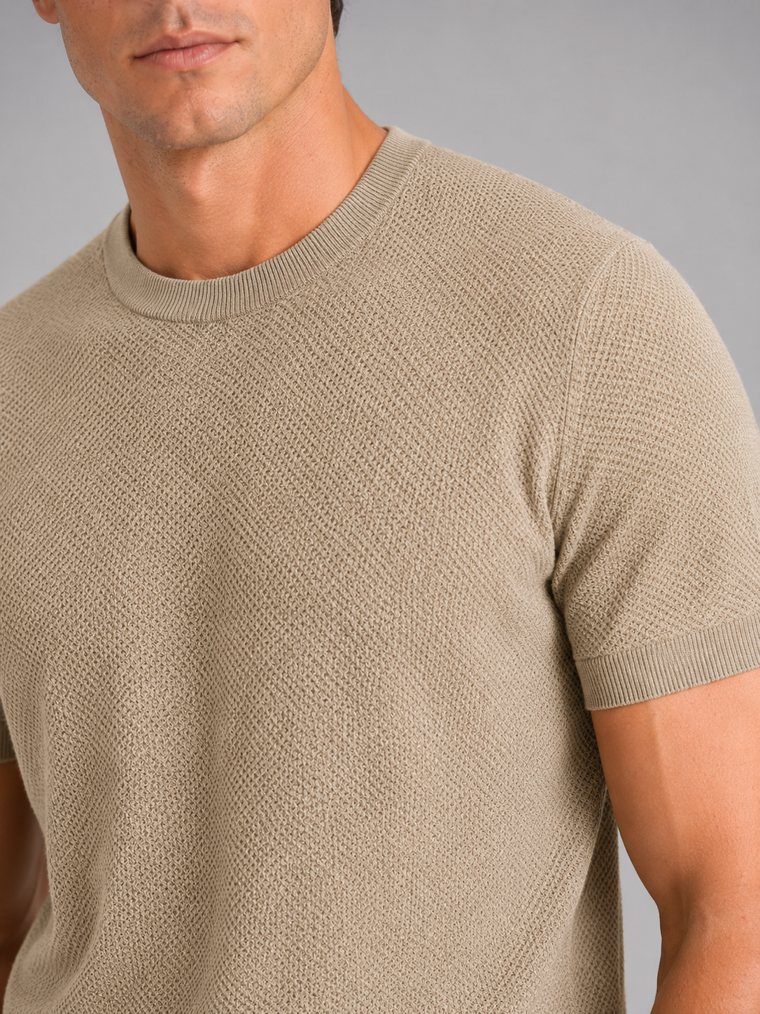 Close up of beige merino wool knit t shirt showing soft breathable texture and crew neck detail