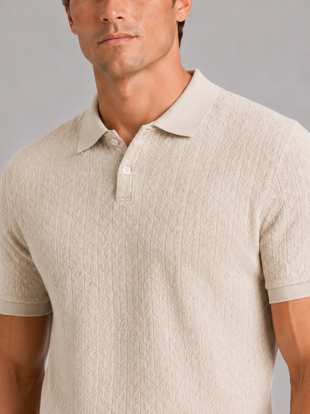 Close up of beige knit polo shirt showing soft breathable fabric and refined collar detail