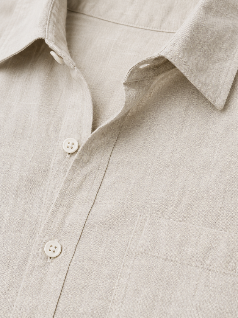 Close up of beige linen shirt fabric showing soft breathable natural woven texture