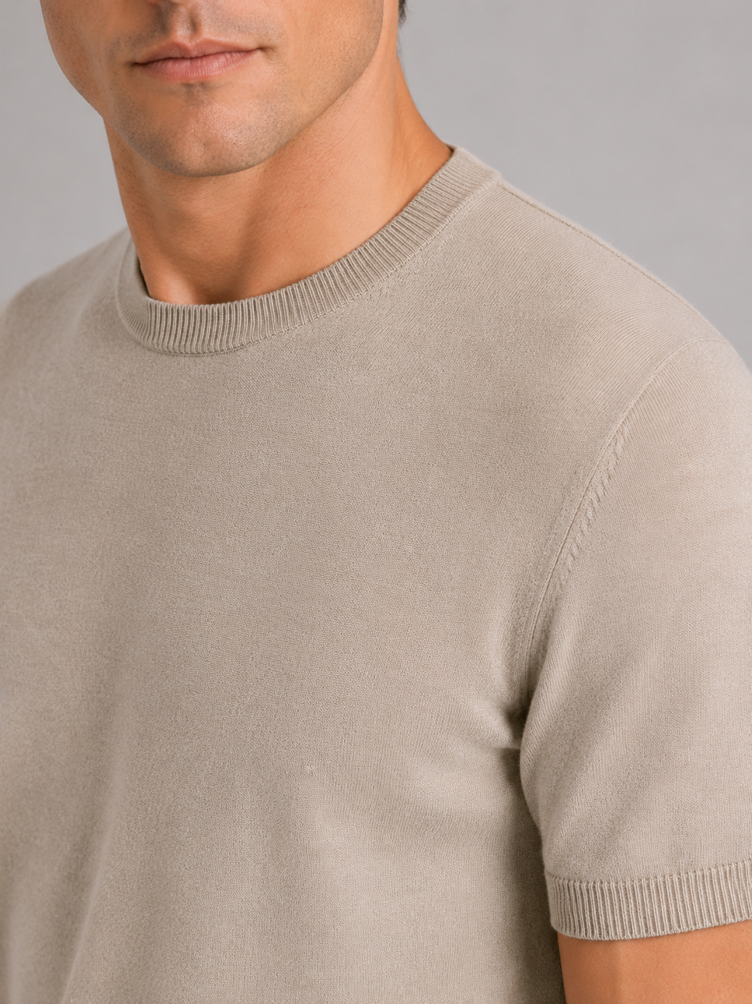 Close up of beige merino wool knit t shirt showing soft breathable texture and crew neck detail