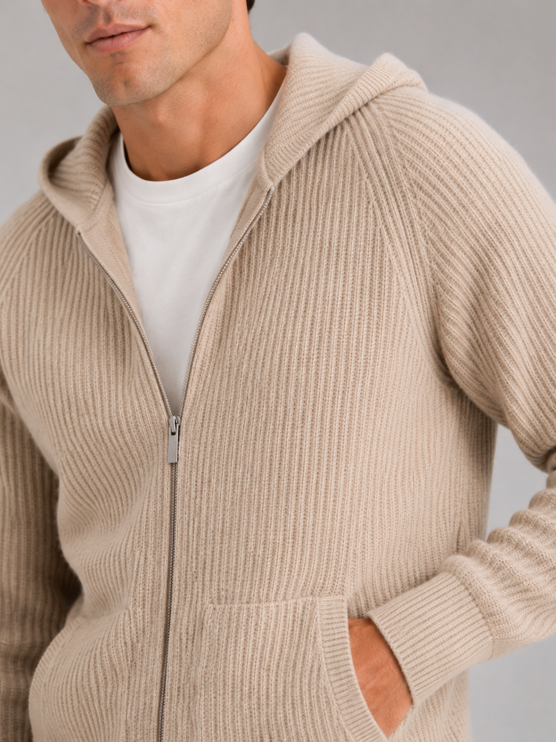 Close up of beige merino wool cardigan showing thick knit texture and zipper detail
