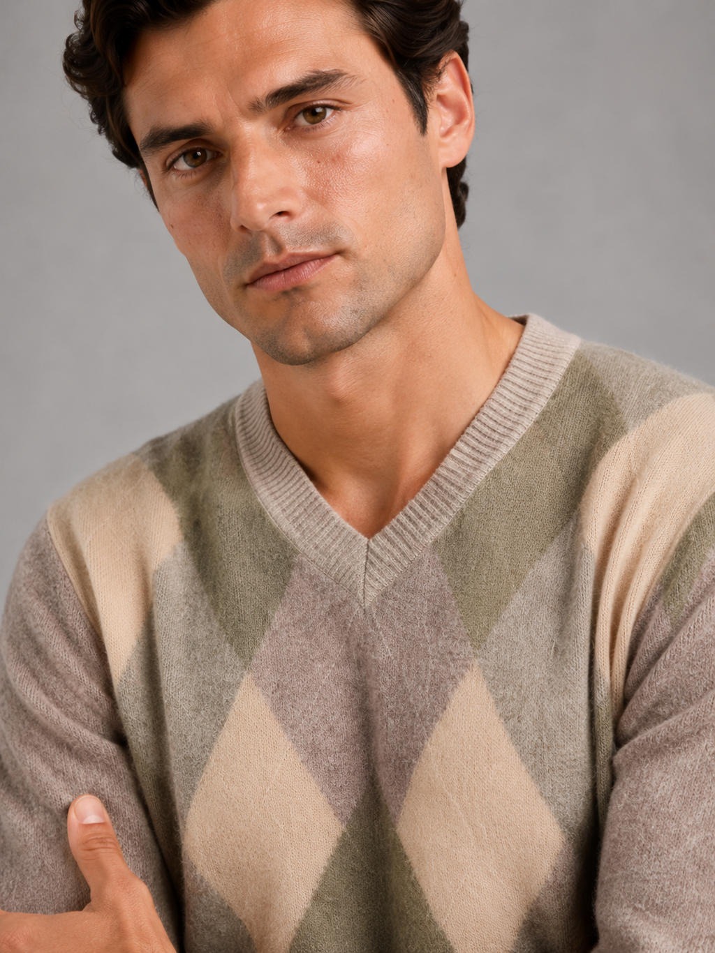 Close up of beige plaid knit sweater showing soft textured fabric and refined v neck detail
