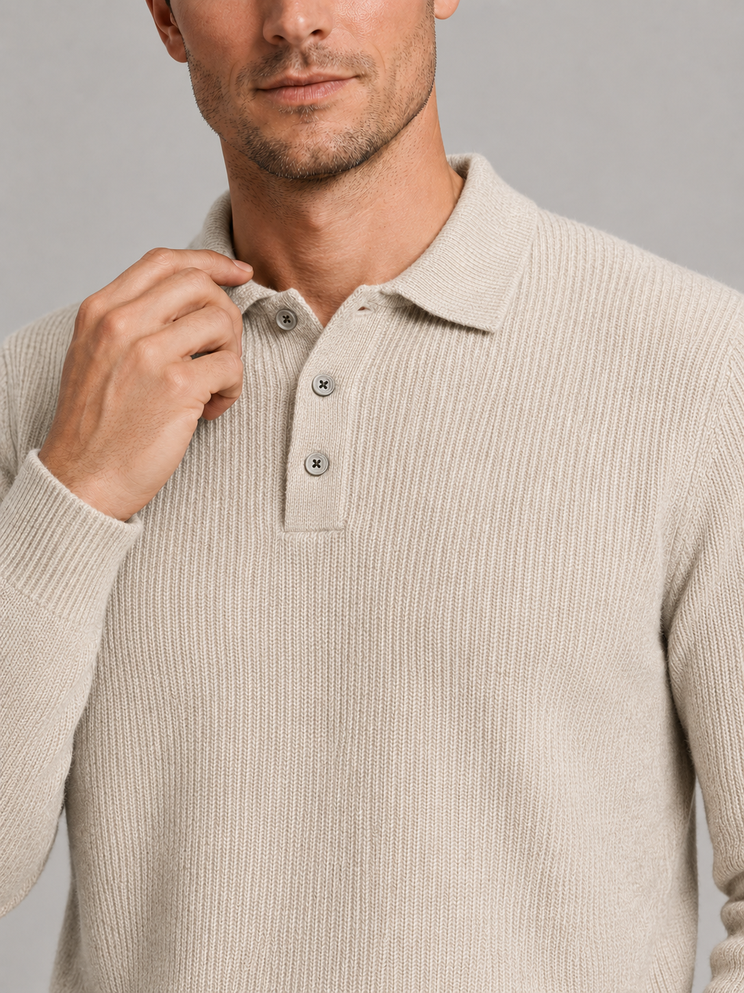 Close up of beige polo neck sweater showing soft knit texture and refined high collar detail