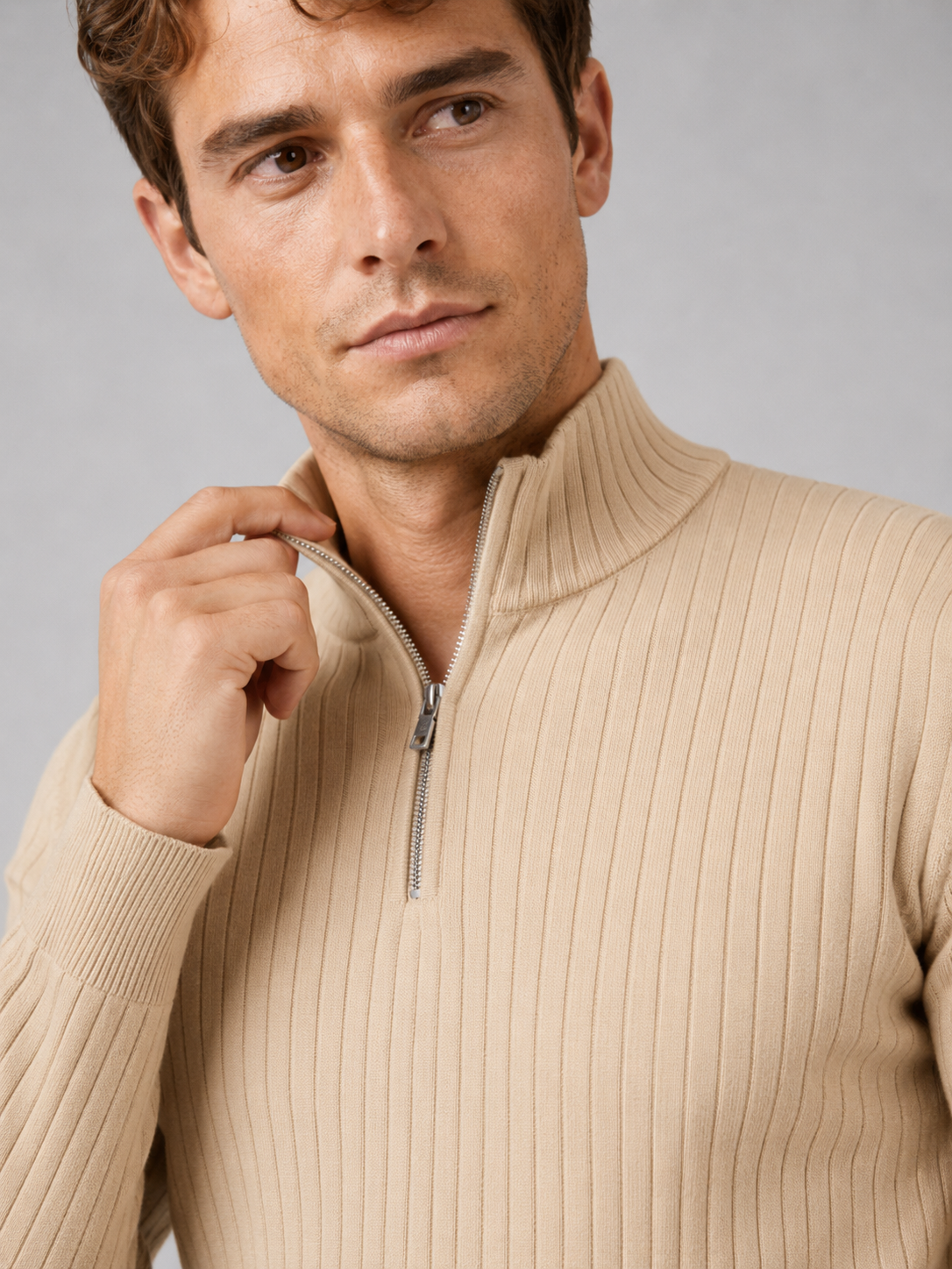 Close up of beige quarter zip sweater showing soft knit texture and mock neck zipper detail