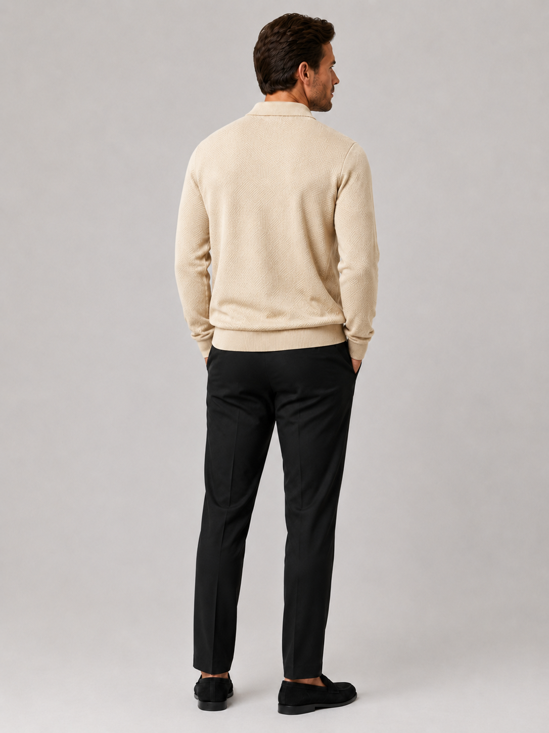 Back view of a man wearing a beige quarter zip knit polo sweater showing the lightweight fabric and regular fit