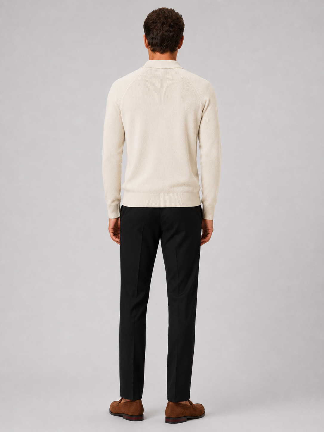 Back view of a man wearing a khaki quarter zip knit polo sweater showing the slim fit and long sleeves