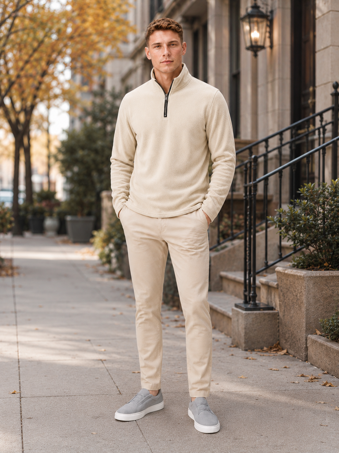 Man styling beige quarter zip fleece sweater in a refined outdoor and winter lifestyle outfit