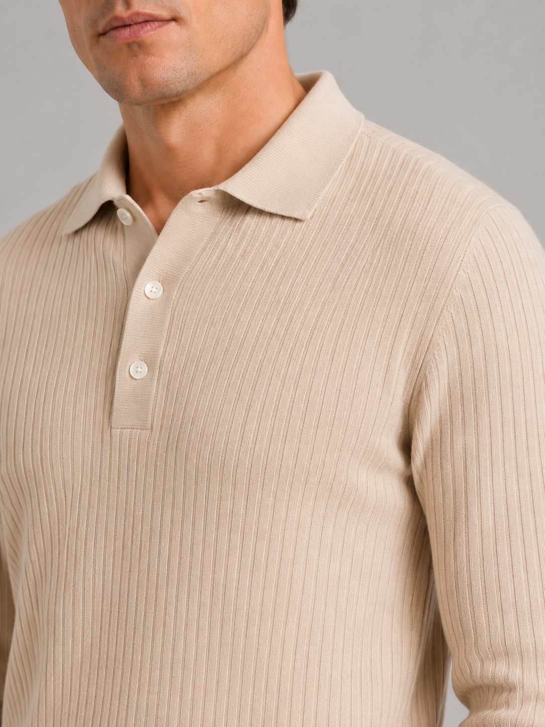 Close up of beige ribbed polo shirt showing soft textured fabric and refined collar detail