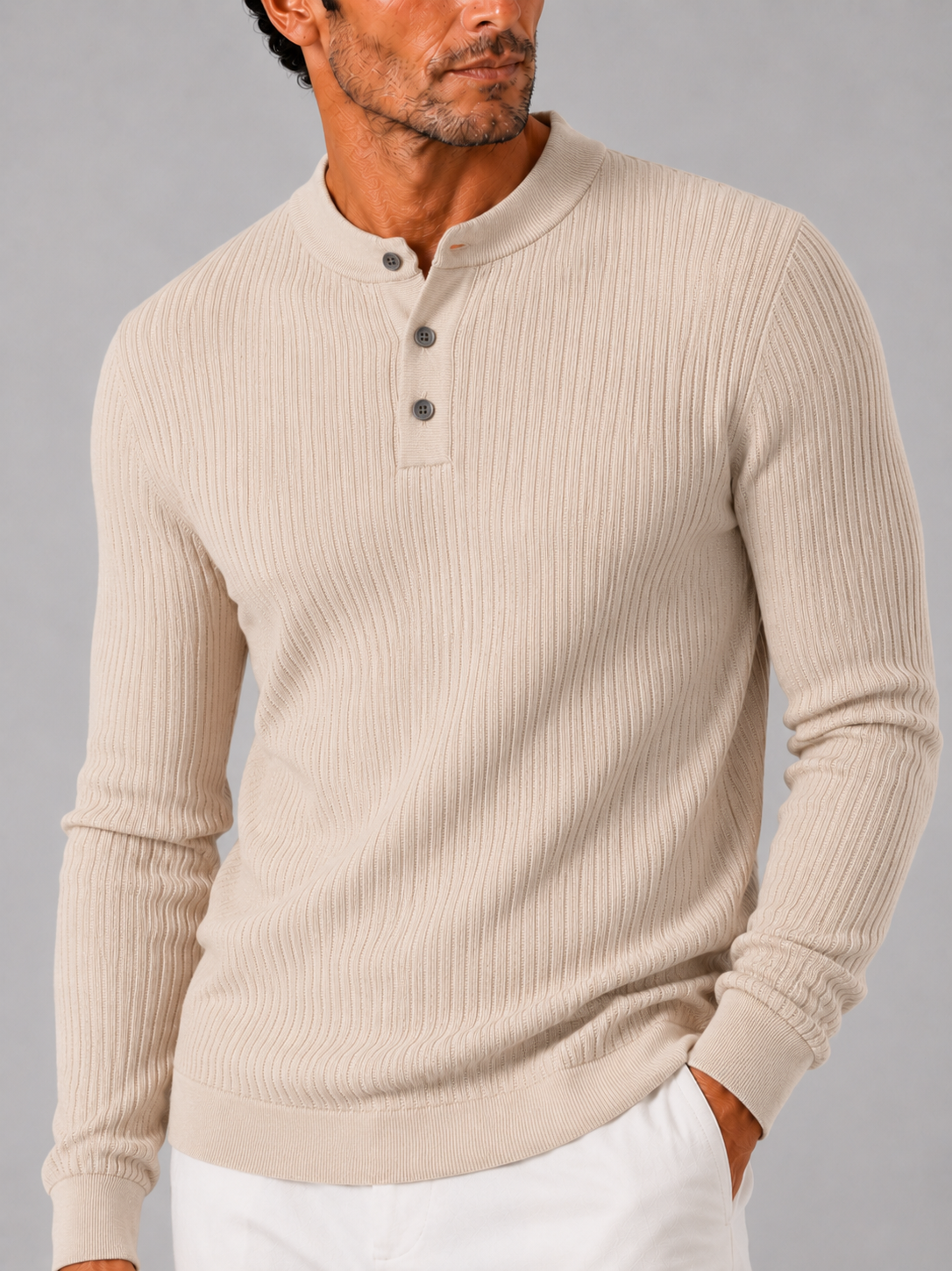 Close up of beige ribbed henley polo showing striped knit texture and button detail