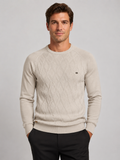 Front view of a man wearing a beige argyle crew neck sweater with long sleeves and a warm knit pattern