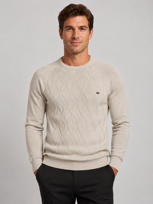 Front view of a man wearing a beige argyle crew neck sweater with long sleeves and a warm knit pattern