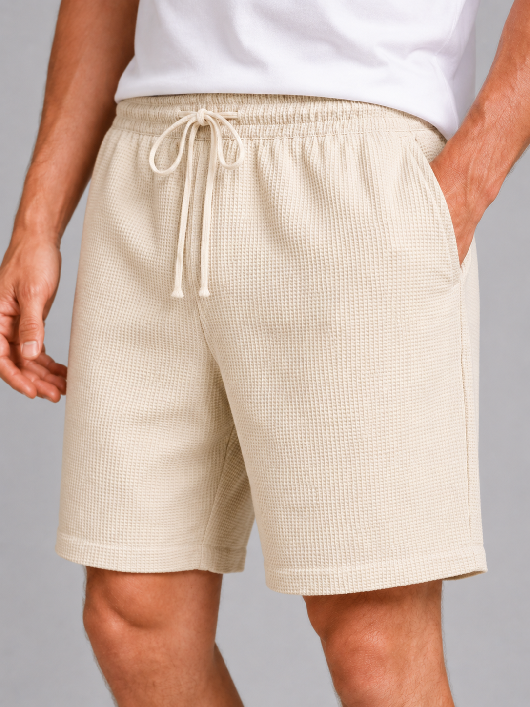 Close up of beige waffle texture shorts showing breathable fabric and adjustable drawstring waistband