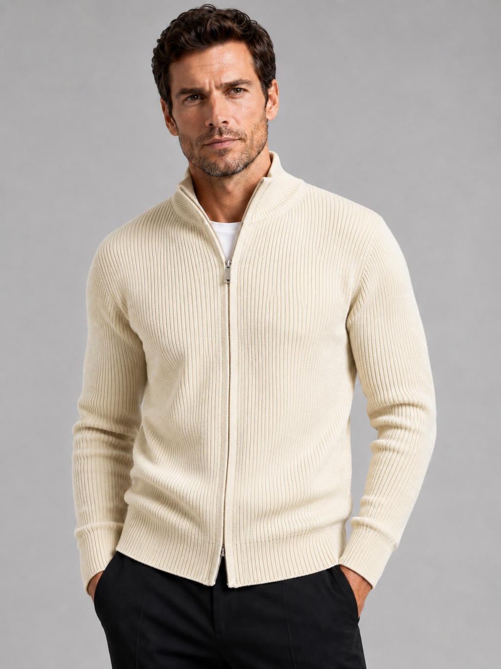 Front view of a man wearing a beige ribbed knit cardigan sweater with a full zip front, stand collar, slim fit, and long sleeves