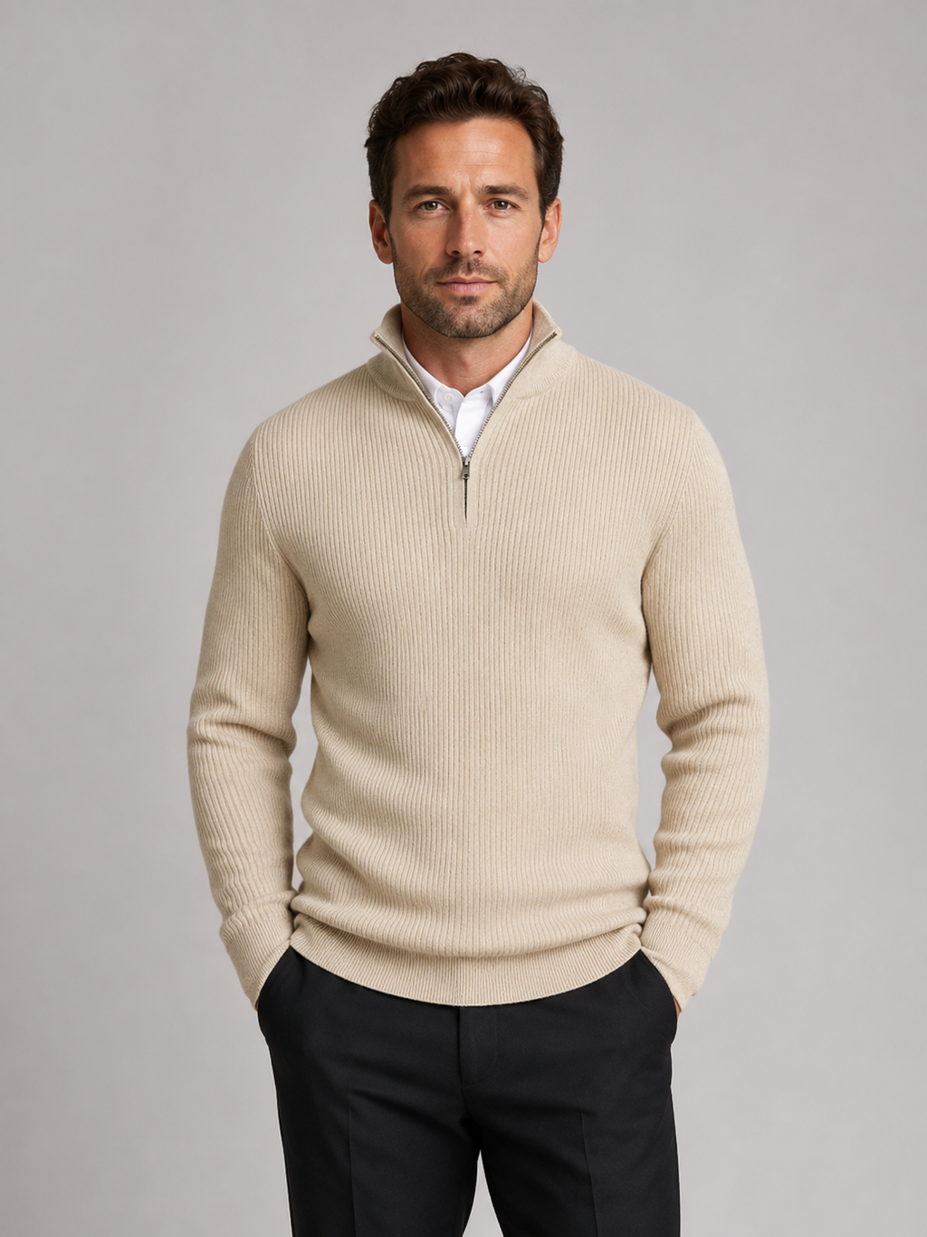 Front view of a man wearing a beige slim fit quarter zip sweater with a mock neck and long sleeves