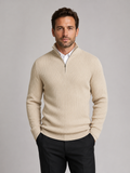 Front view of a man wearing a beige slim fit quarter zip sweater with a mock neck and long sleeves