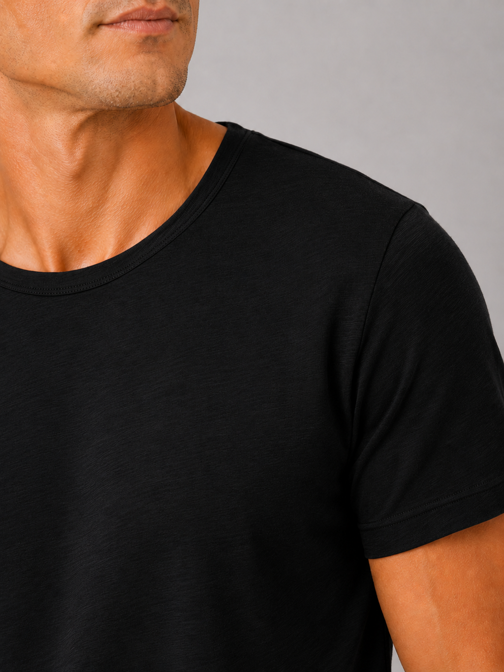 Close up of black cotton t shirt showing soft breathable fabric and clean crew neck detail