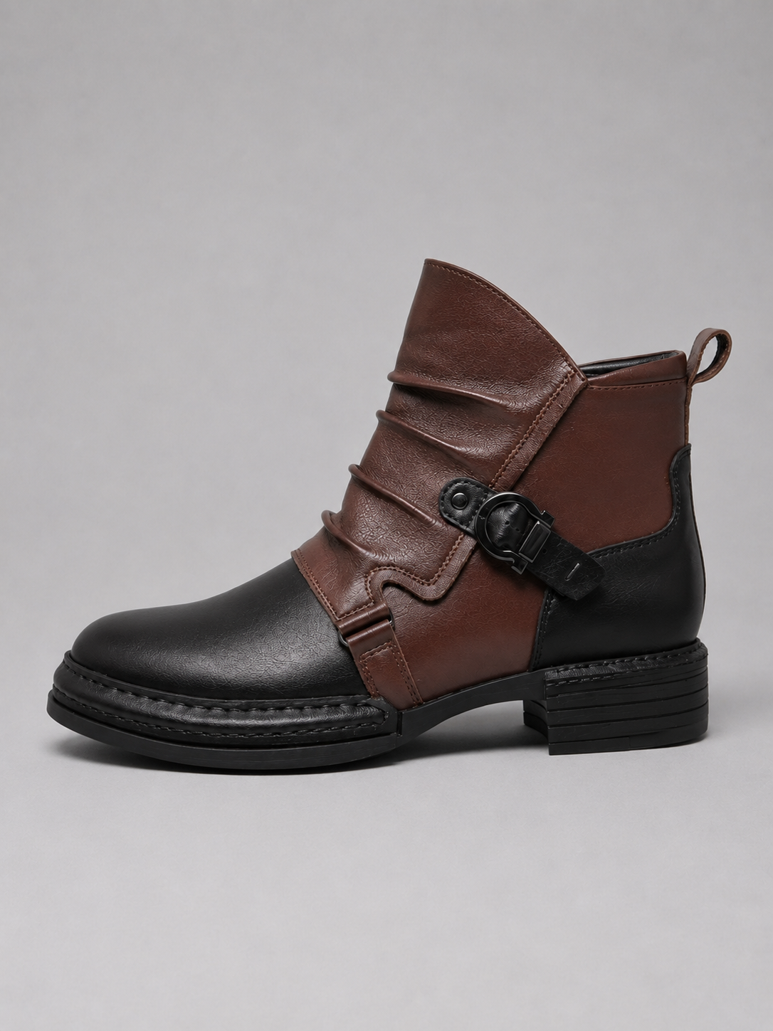 Black men’s zip-up ankle motorcycle boots displayed on a plain background showing the full side profile and rugged sole