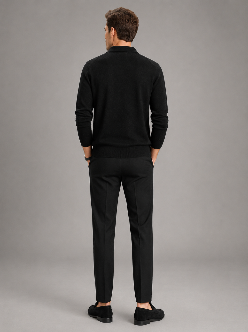 Back view of a man wearing a beige argyle cardigan showing the thick knit fabric, long sleeves, collar, and comfortable fit