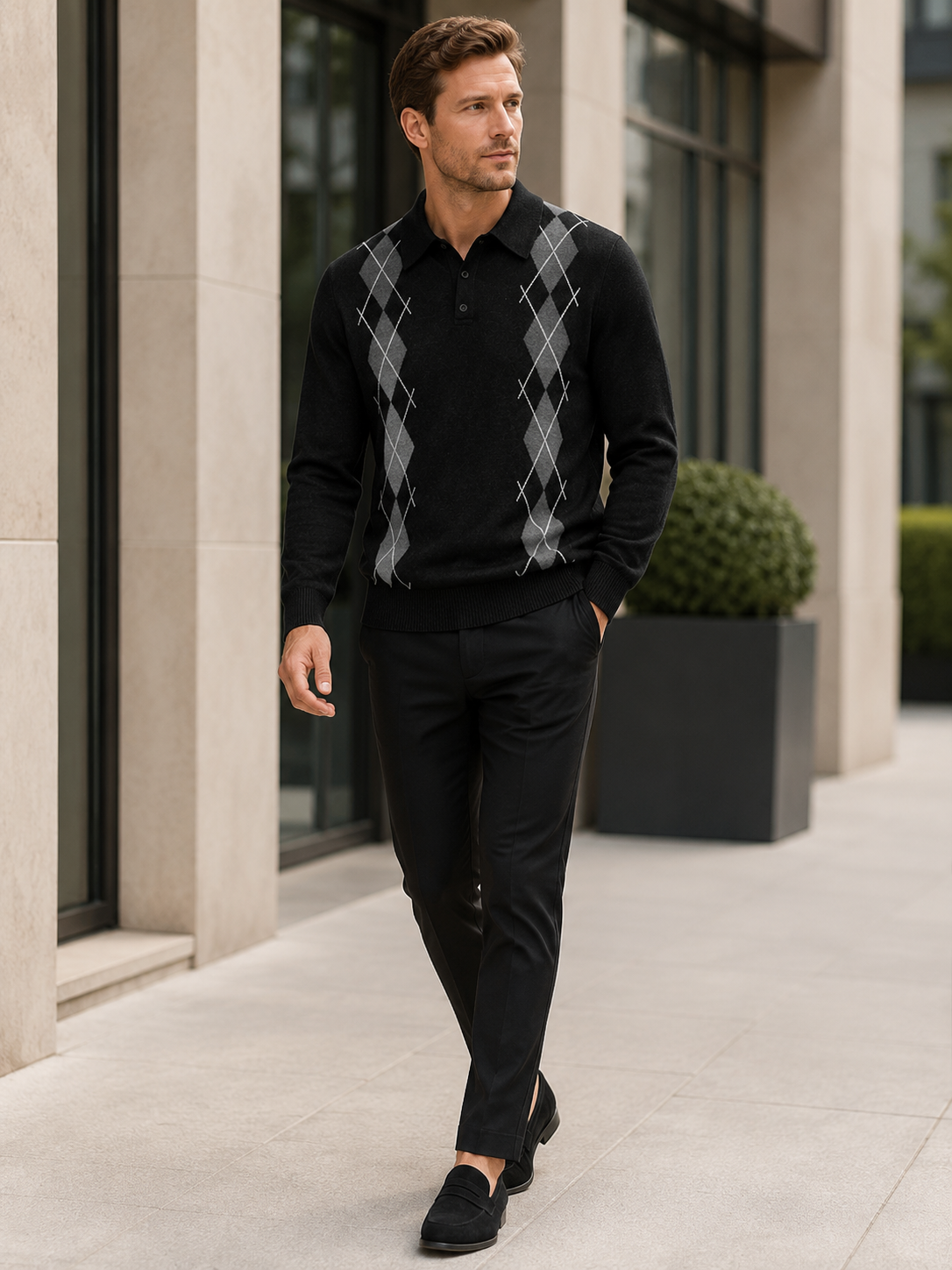 Man wearing a black argyle plaid knit sweater with a contrast collar in a business casual fall winter outfit