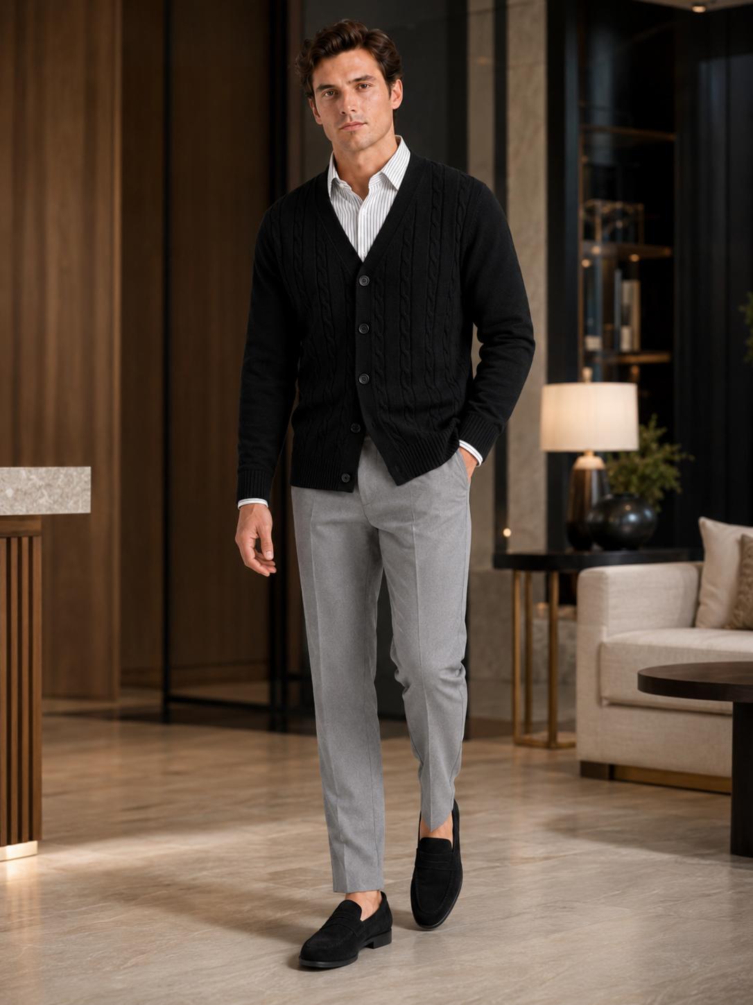 Man styling black cable knit cardigan in a refined fall winter lifestyle outfit
