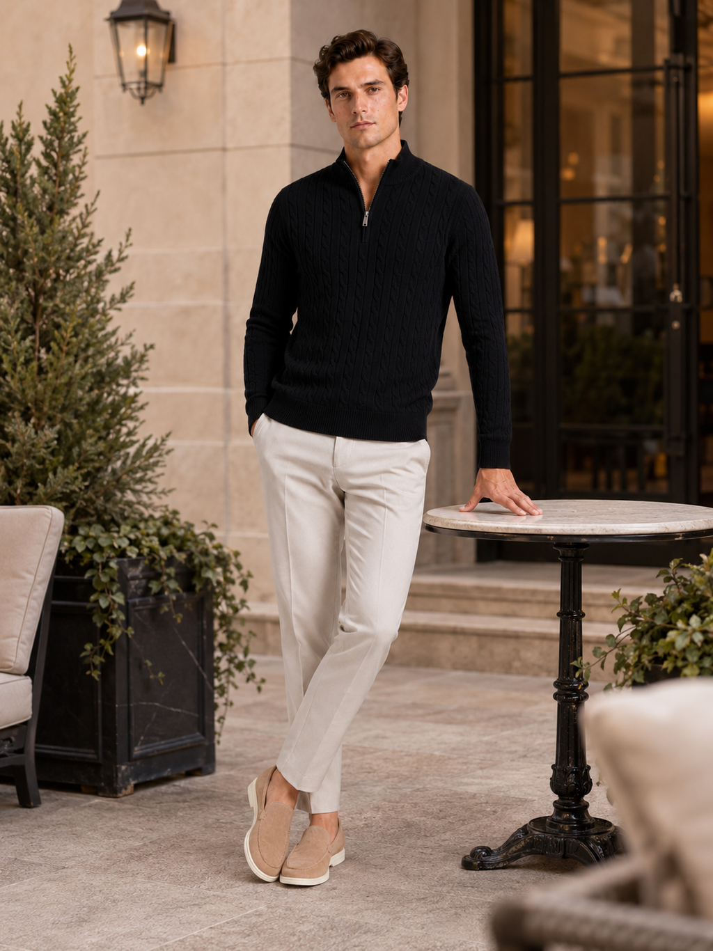 Man styling black cable knit quarter zip sweater in a modern fall winter lifestyle outfit
