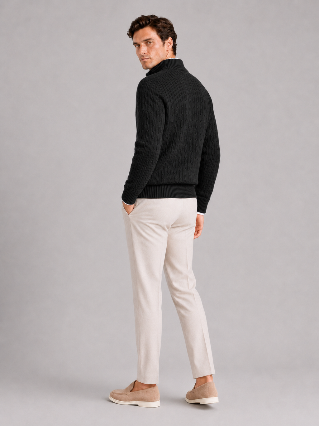 Man styling black cashmere quarter zip sweater in a modern fall winter lifestyle outfit