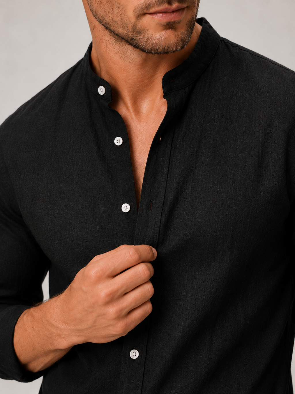 Close up of black cotton linen shirt showing lightweight breathable fabric and band collar detail