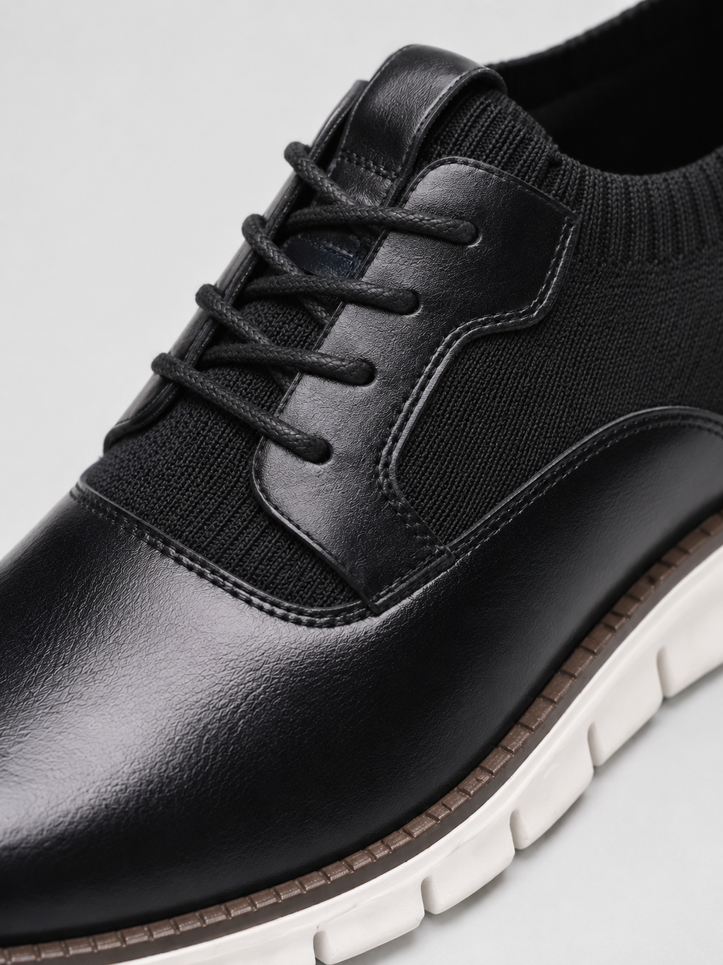 Close up of black dress shoes showing smooth leather texture and secure lace up detail