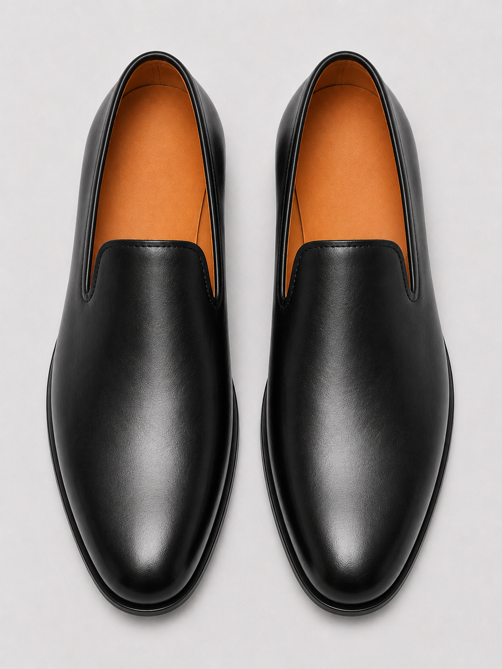 Close up of black leather driving loafers showing smooth leather texture and refined slip on design