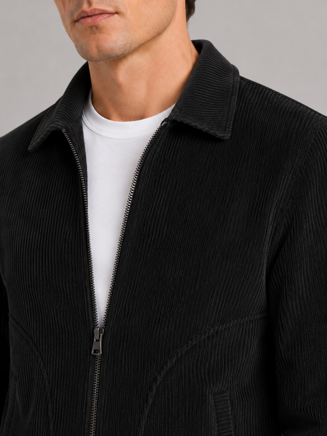 Close up of black corduroy jacket showing soft ribbed texture and warm fabric detail