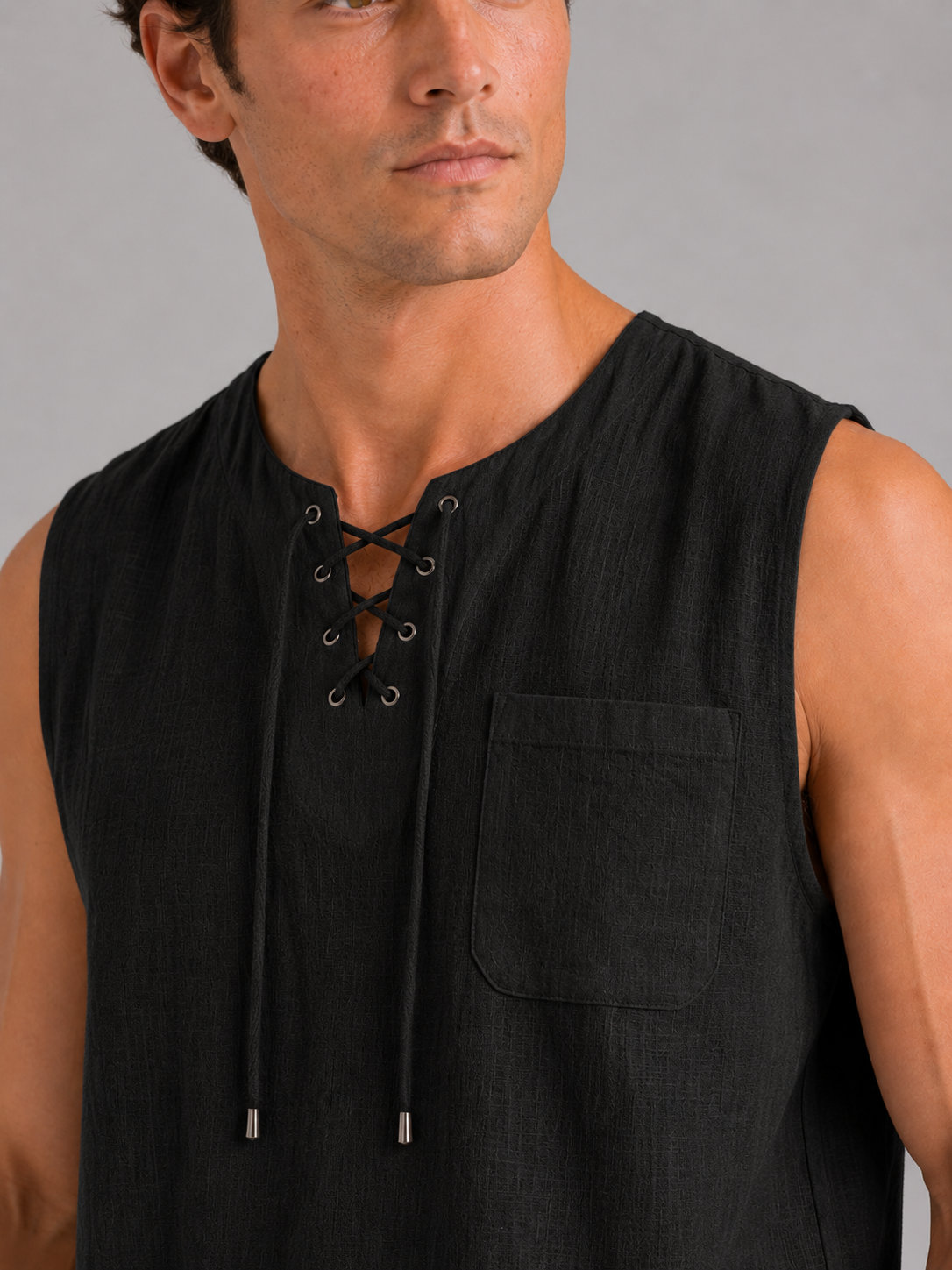 Close up of black cotton linen tank top showing breathable fabric texture and lace up neckline detail