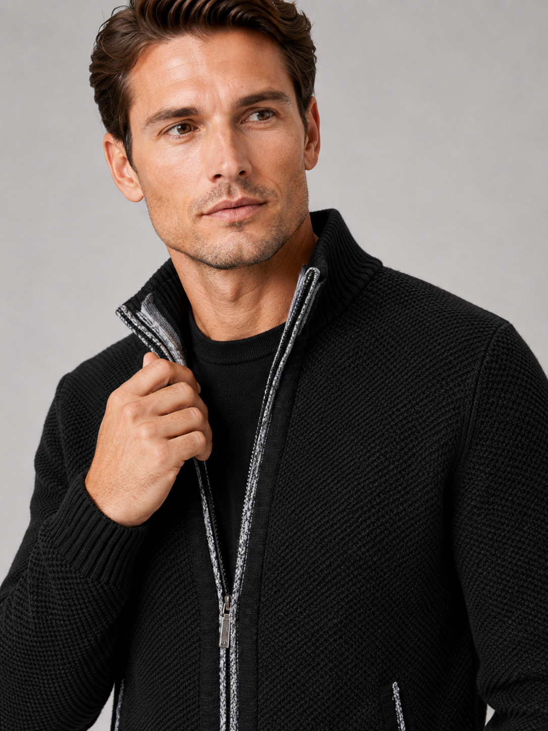 Close up of black fleece cardigan showing soft knit texture, full zip front, and warm fleece lining detail
