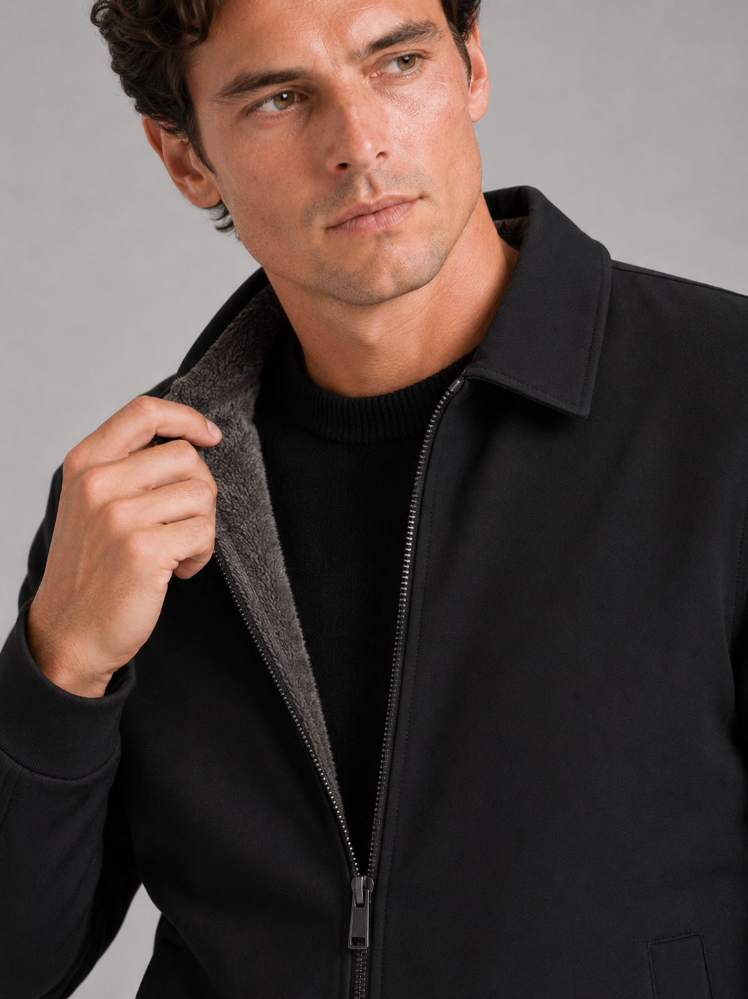 Close up of black fleece lined jacket showing soft thermal lining and classic turn down collar detail