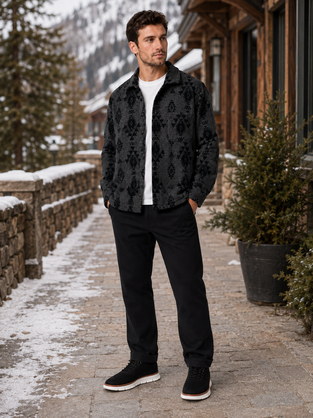 Man wearing a black heavyweight flannel shacket in a rugged casual outdoor fall winter outfit with dark jeans
