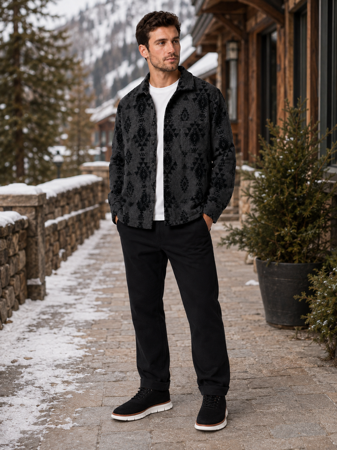 Man wearing a black heavyweight flannel shacket in a rugged casual outdoor fall winter outfit with dark jeans