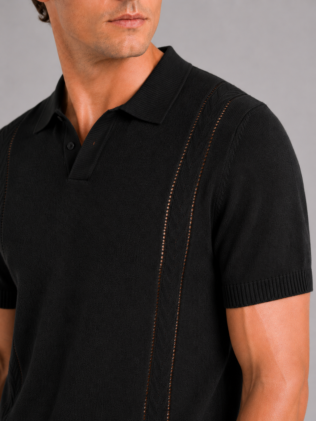 Close up of black knit polo shirt showing soft breathable fabric and refined collar detail