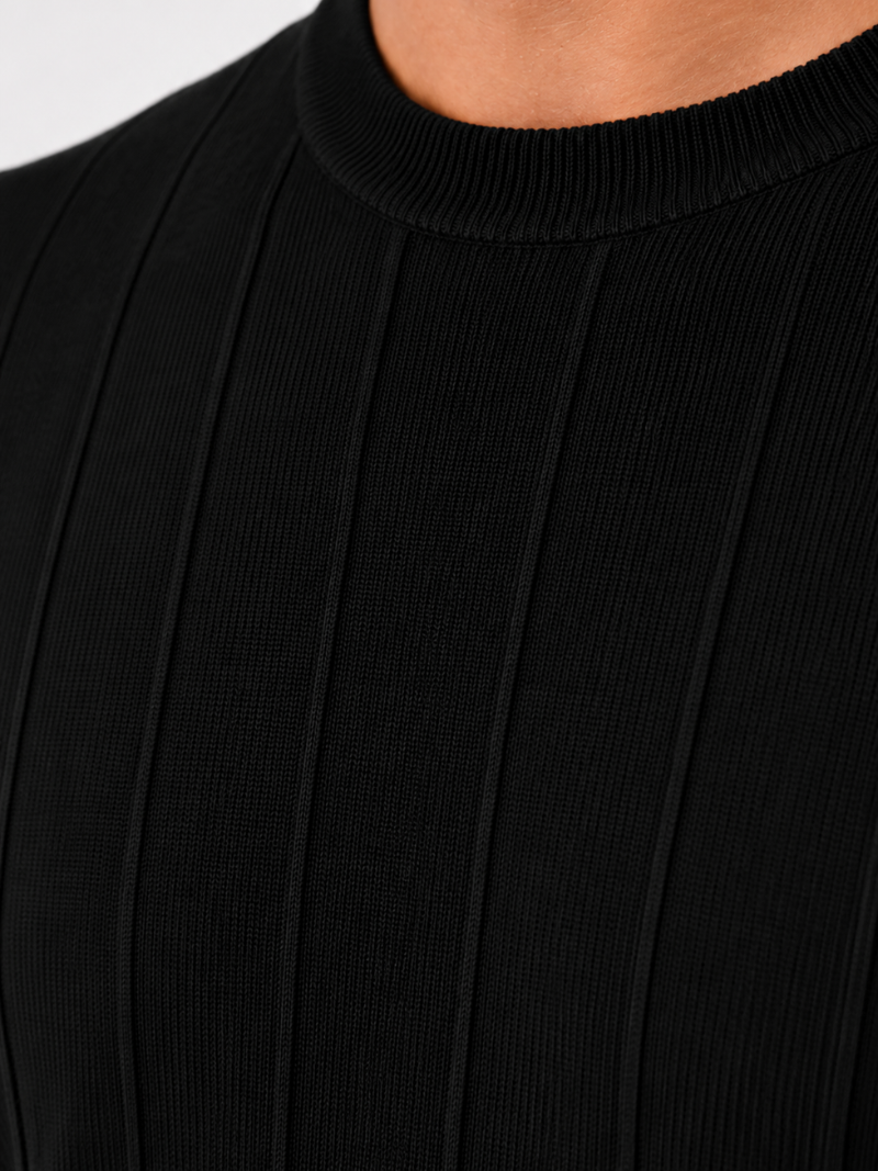 Close up of black knit t shirt fabric showing soft breathable ribbed texture and premium finish